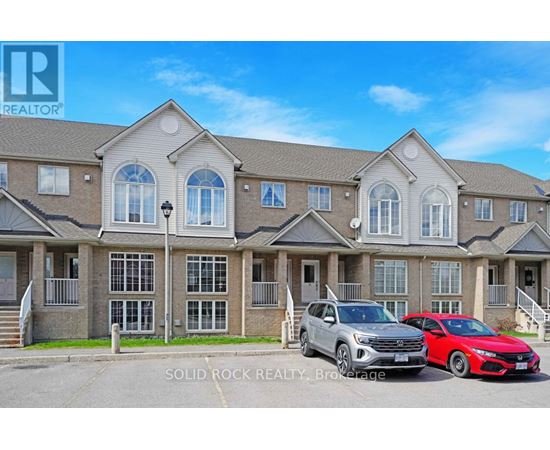 A row of houses with two cars parked in front.