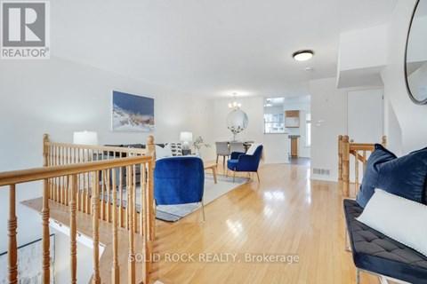 A living room with a blue chair and a couch.