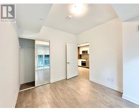 A spacious room with a door leading to another room.
