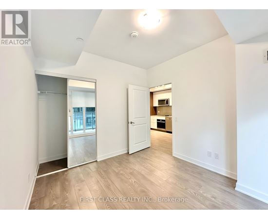 A spacious room with a door leading to another room.