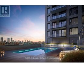 A modern apartment building with a pool on the roof.