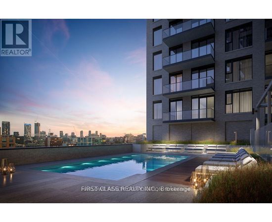 A modern apartment building with a pool on the roof.