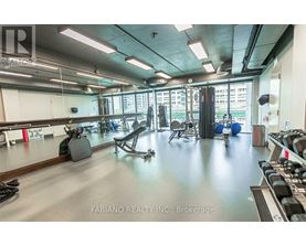 A gym with a variety of equipment including weights and exercise machines.