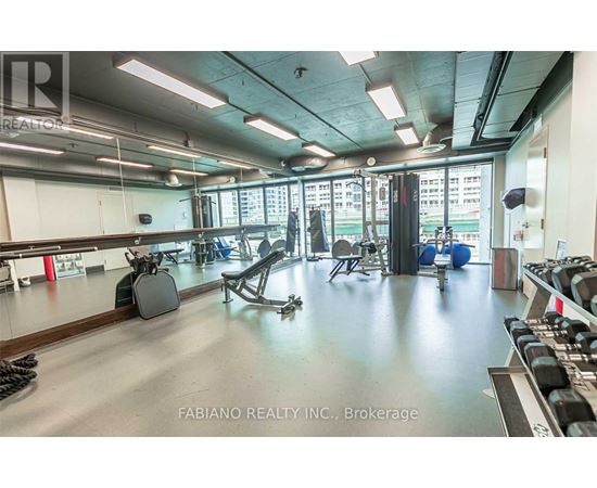 A gym with a variety of equipment including weights and exercise machines.