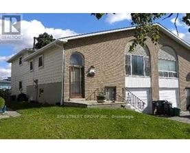 A two-story house with a garage is for sale.