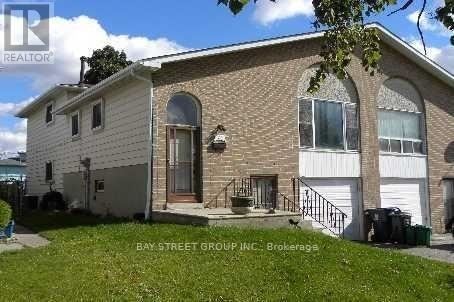 A two-story house with a garage is for sale.