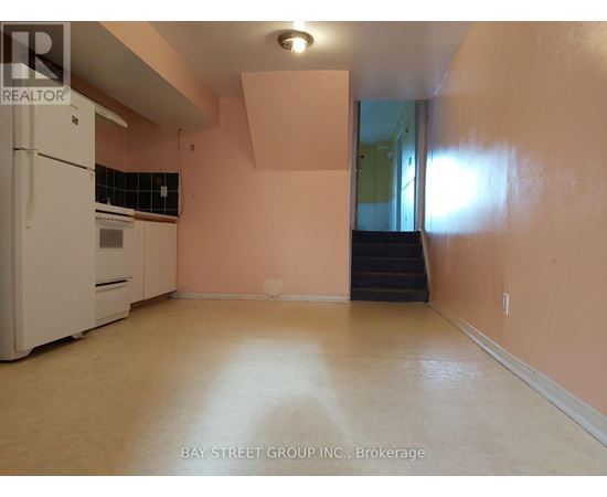 A kitchen with a white refrigerator and a stove top oven.