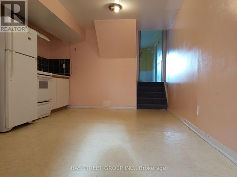 A kitchen with a white refrigerator and a stove top oven.