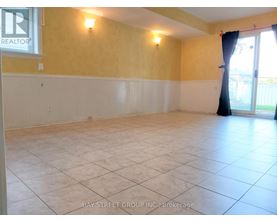 A spacious room with yellow walls and white trim.