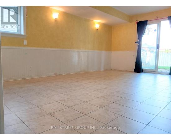 A spacious room with yellow walls and white trim.
