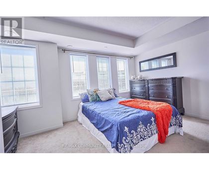 A bedroom with a bed, dresser, and window.