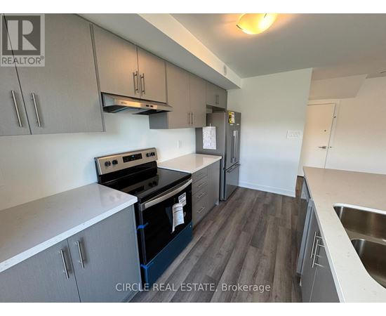 A kitchen with a stove top oven and a refrigerator.