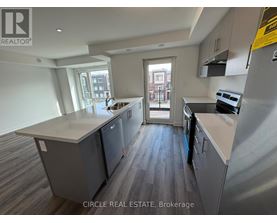 A kitchen with a large island and a view of the city.