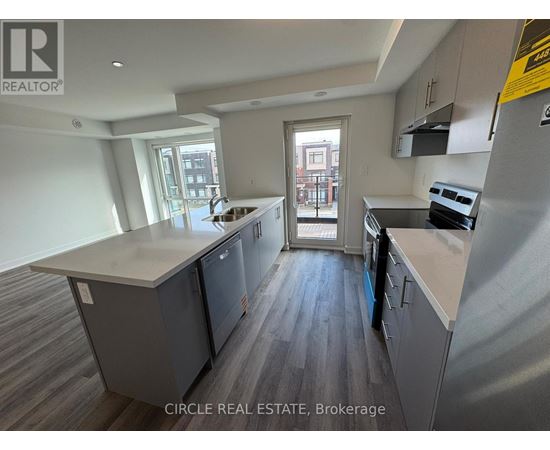 A kitchen with a large island and a view of the city.