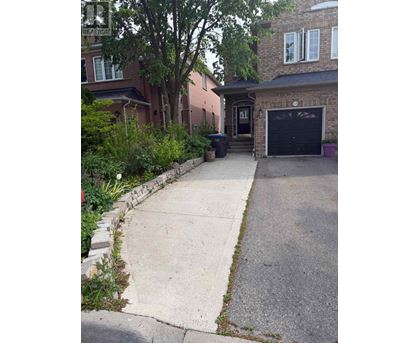 A black garage door is on the right side of the house.