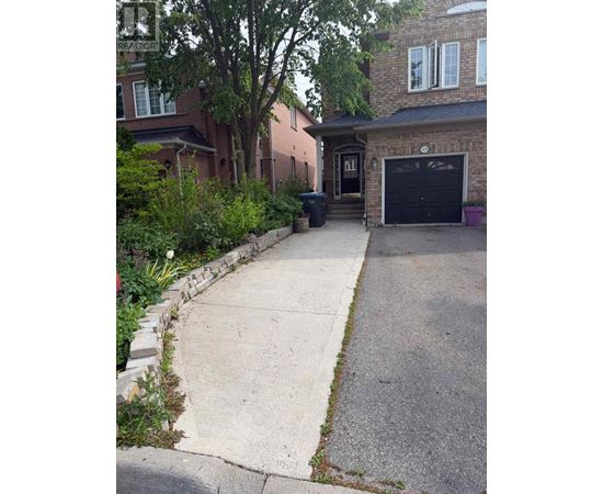 A black garage door is on the right side of the house.