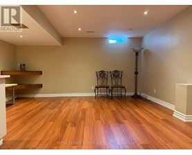 A room with wooden floors and a skylight.