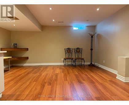 A room with wooden floors and a skylight.