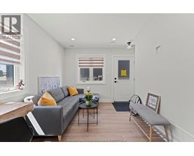 A living room with a grey couch and a coffee table.