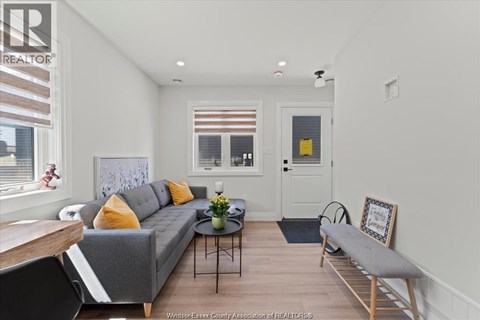 A living room with a grey couch and a coffee table.