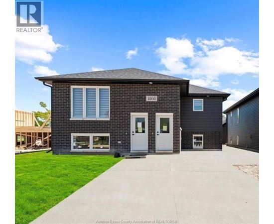 A house with a grey roof and a white door is for sale.
