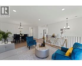A living room with a grey sofa, a blue armchair, a coffee table, and a dining table with chairs.