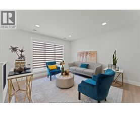 A living room with a grey couch, a blue chair and a white coffee table.