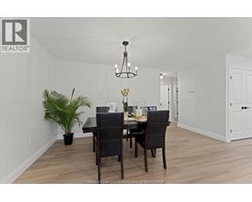 A dining room with a table set for two.