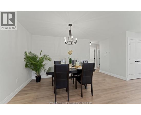 A dining room with a table set for two.