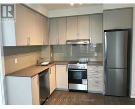 A kitchen with a refrigerator, oven, and sink.