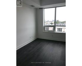 A room with a large window and a view of the city.