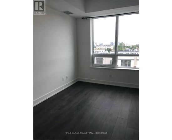 A room with a large window and a view of the city.