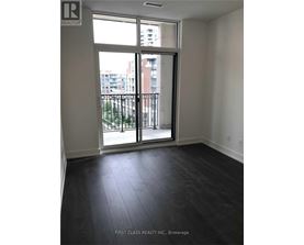 A room with a sliding glass door leading to a balcony.