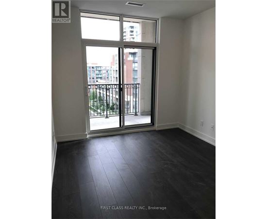 A room with a sliding glass door leading to a balcony.
