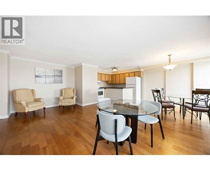 A dining room with a table and chairs.
