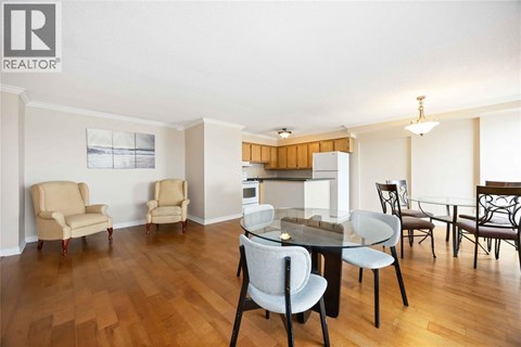 A dining room with a table and chairs.