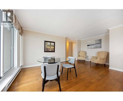 A living room with a table and chairs.