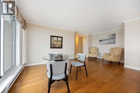 A living room with a table and chairs.