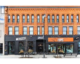 A red brick building with a black awning that says Alpine.