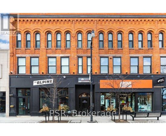 A red brick building with a black awning that says Alpine.