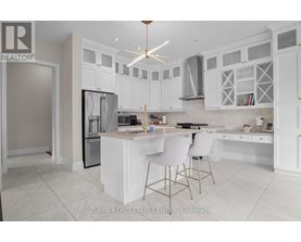 A modern kitchen with white cabinets and a central island.