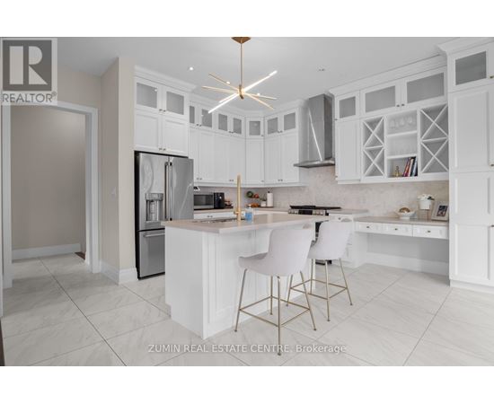 A modern kitchen with white cabinets and a central island.