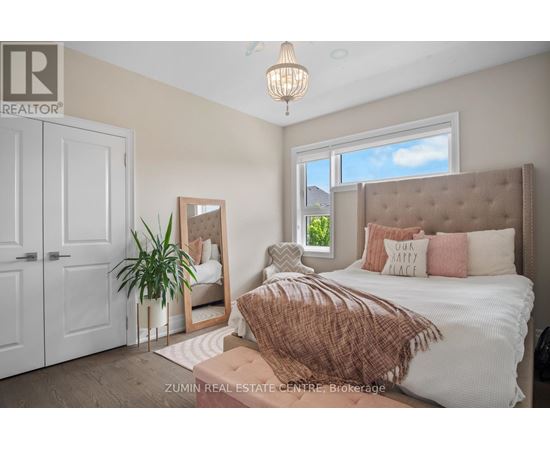 A bedroom with a large bed and a mirror on the wall.