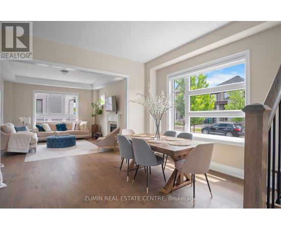 A well-lit living room with a dining table and chairs.