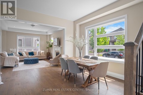 A well-lit living room with a dining table and chairs.