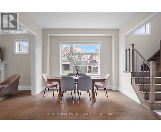 A dining room with a table set for four.