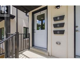 A white door is on the right side of a black railing.