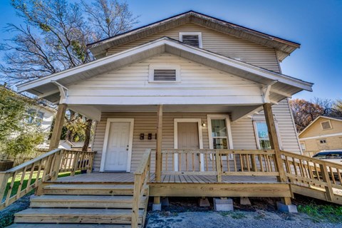 A house with a white door and a porch.