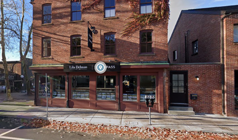 A brick building with a sign that says "Lila Delaney" on it.