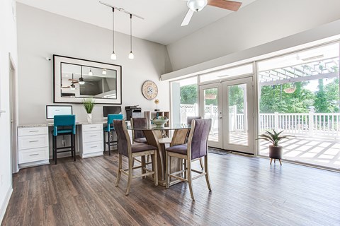 A dining room with a table and chairs.